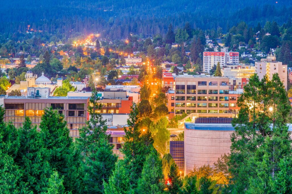 Skyline of Eugene, OR, capturing the city's urban charm and Clear to Launch Dental Marketing' innovative dental marketing strategies tailored for Eugene dental practices.