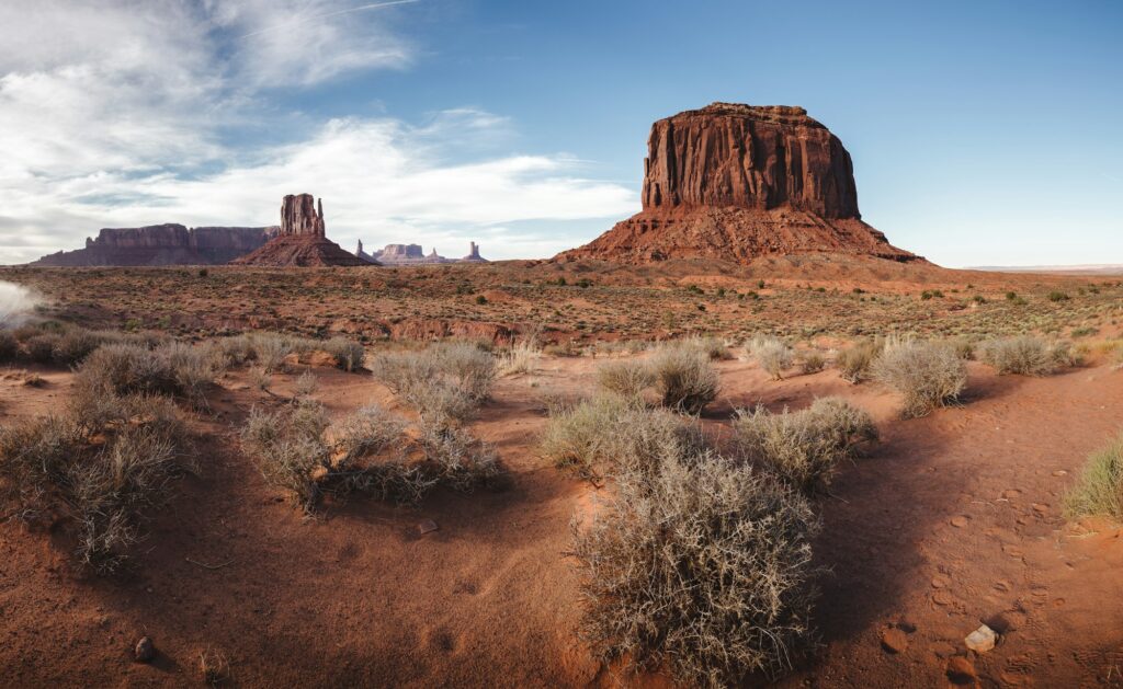 Late afternoon scene in Monument Valley, Utah, showcasing the iconic red rock formations and vast desert landscape, representing the timeless and enduring dental marketing strategies of Clear to Launch Dental Marketing for West Valley City dental practices.