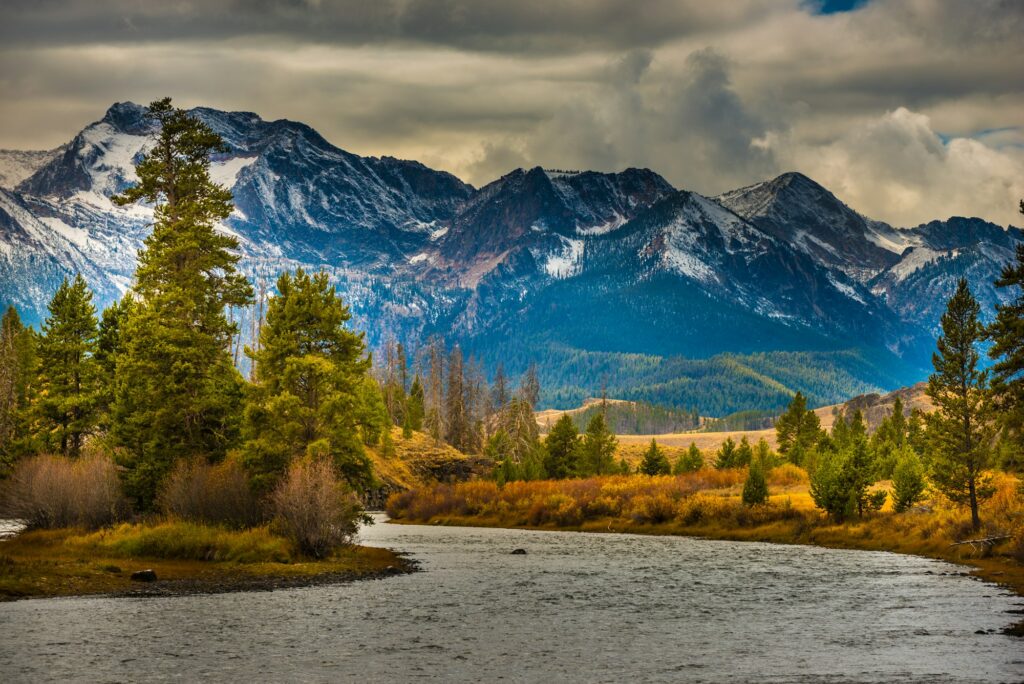 Scenic river flowing in front of majestic mountain scenery in Idaho, near Nampa, representing the natural beauty and growth potential Clear to Launch Dental Marketing brings to dental marketing for Nampa dental practices.