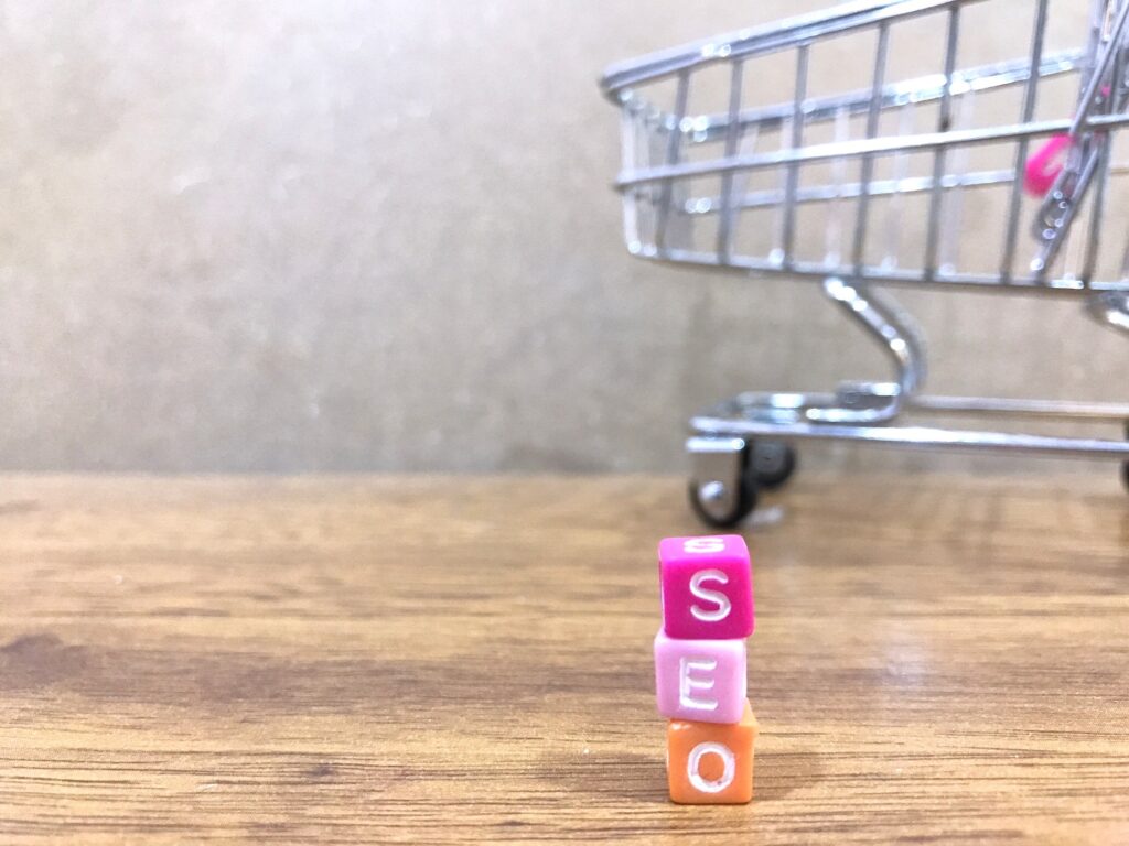 Colorful letter blocks spelling SEO next to a shopping cart, symbolizing the concept of dental SEO pricing and choosing the right marketing investment