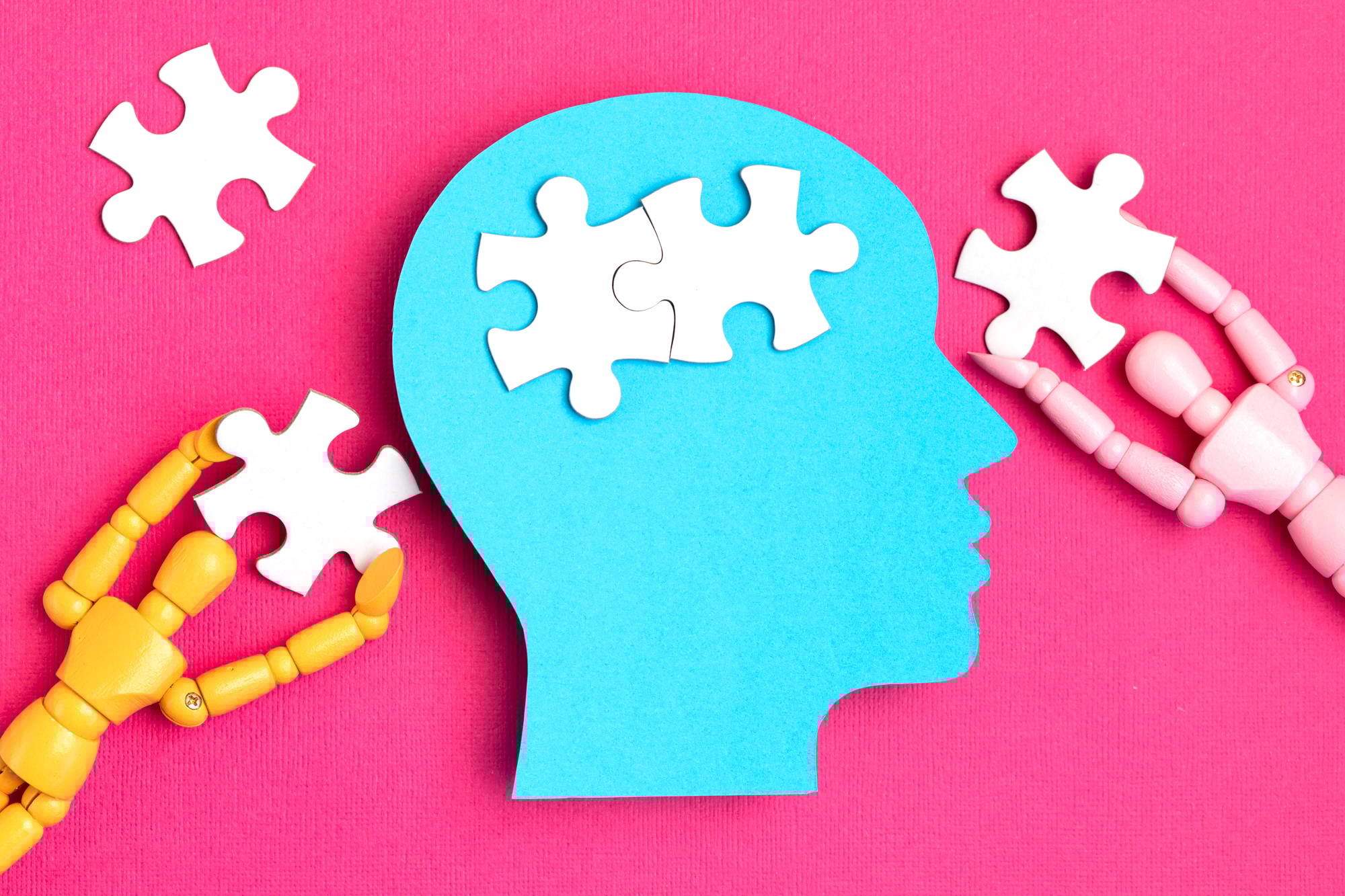 Puzzle pieces forming a brain inside a head silhouette representing Clear to Launch Healthcare Marketing’s insights on the psychology behind effective Healthcare branding