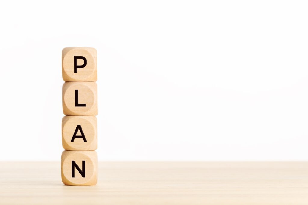 Stacked wooden blocks spelling PLAN to represent building an effective healthcare SEO strategy