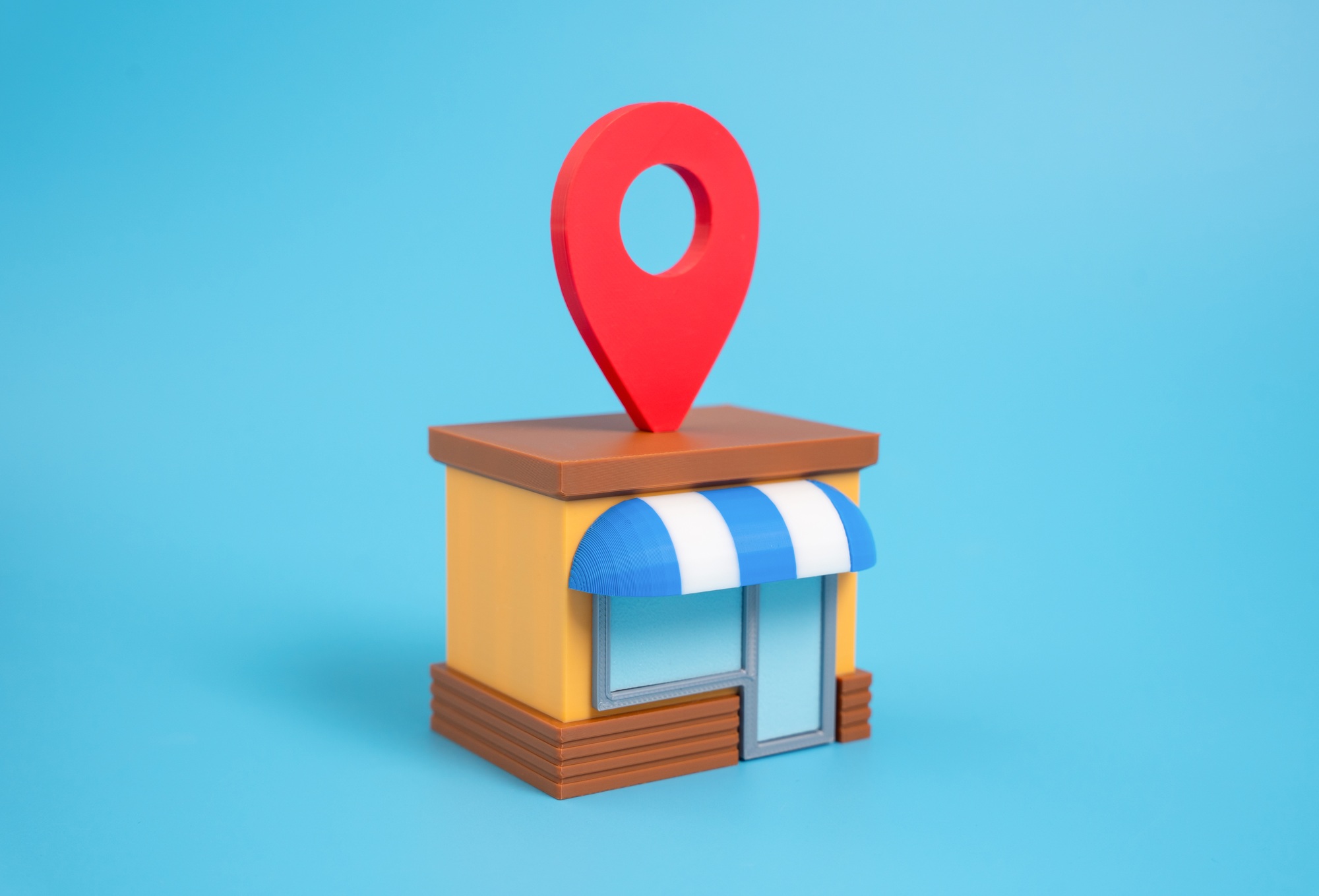 3D illustration of a storefront with location pin, representing Clear to Launch Healthcare Marketing’s focus on local SEO for healthcare practices
