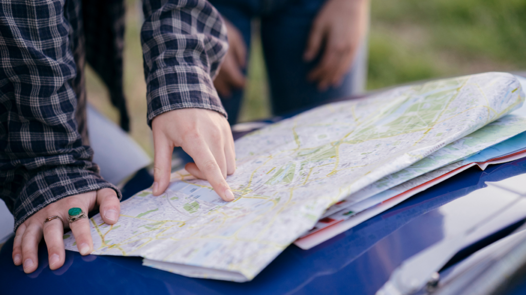 hands reviewing a map to plan multi-location healthcare practice expansion for a multi-location growth road map from Clear to Launch Healthcare Marketing