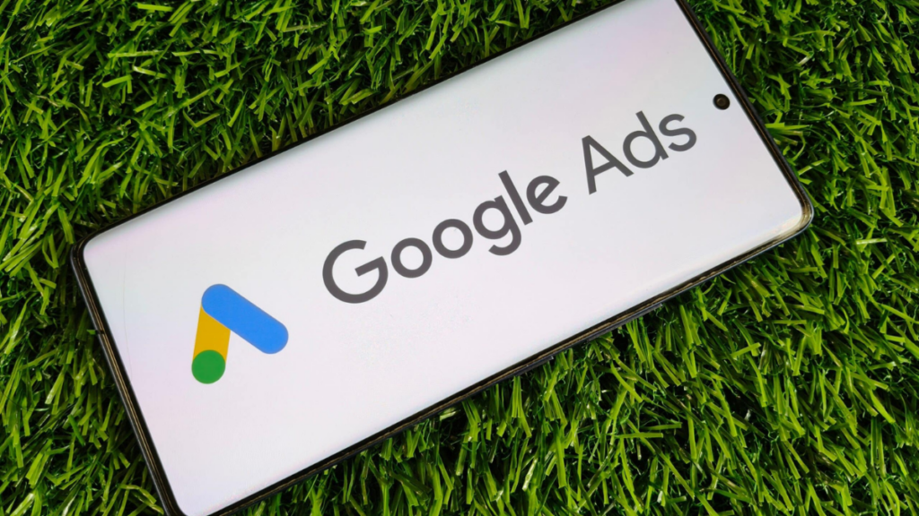 google ads for dentist displayed on phone in green grass - clear to launch